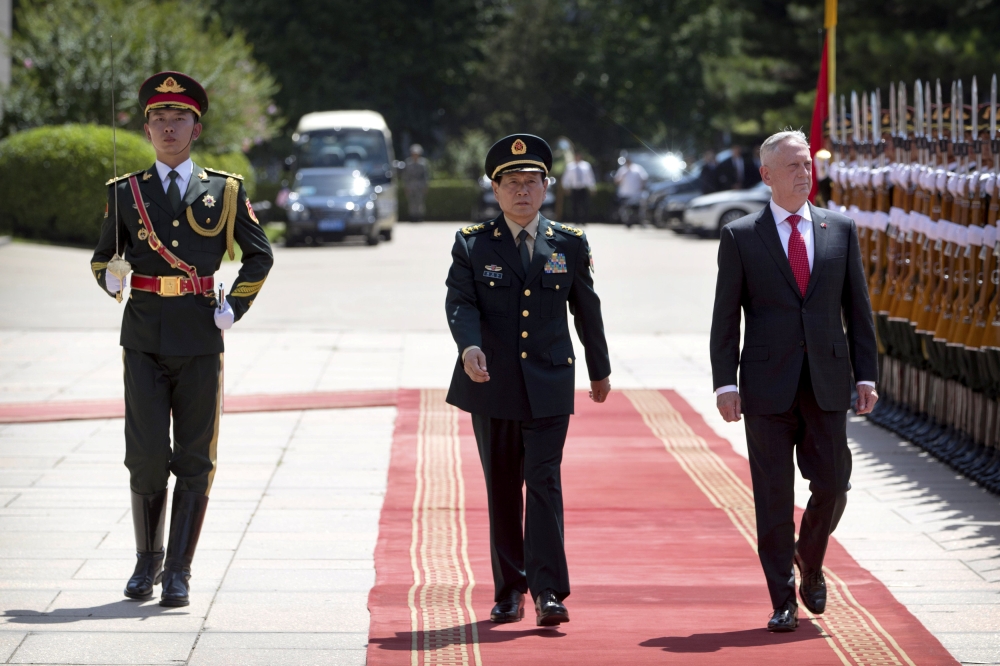 China's Defense Minister Wei Fenghe and U.S. Defense Secretary Jim Mattis review an honor guard during a welcome ceremony at the Bayi Building in Beijing, Wednesday, June 27, 2018. Mark Schiefelbein/Pool via Reuters