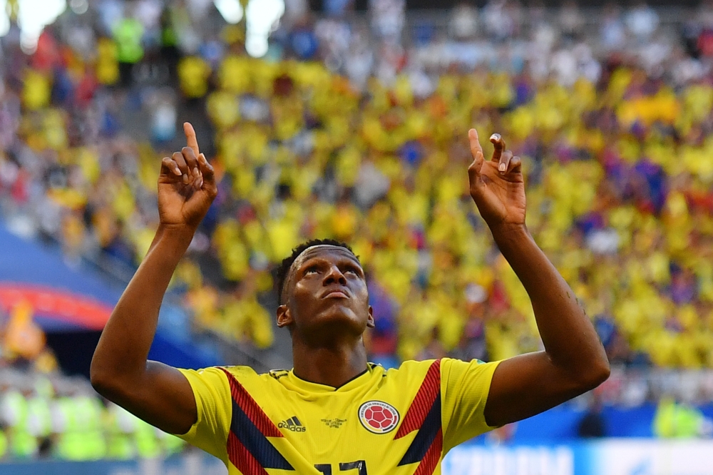 Colombia's defender Yerry Mina (R) celebrates after scoring a goal during the Russia 2018 World Cup Group H football match between Senegal and Colombia at the Samara Arena in Samara on June 28, 2018.  AFP / Manan Vatsyayana