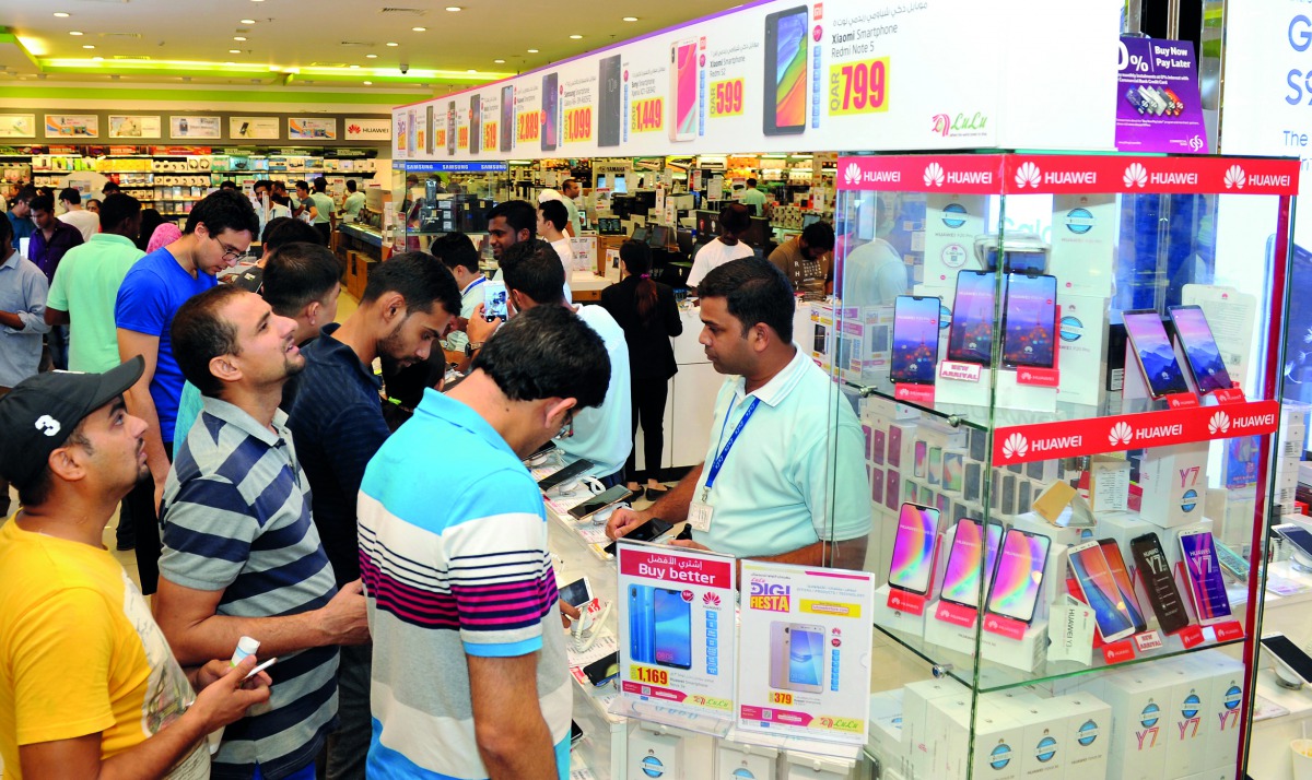 Customers choose mobile phones at Lulu Hypermarket at D Ring Road in Doha. Pic: Salim Matramkot / The Peninsula
