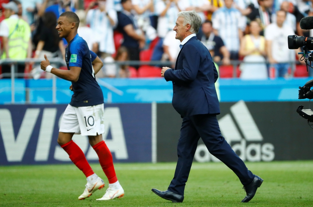 France coach Didier Deschamps and Kylian Mbappe celebrate victory after the match REUTERS/Michael Dalder

