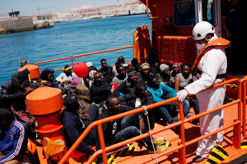 Migrants intercepted aboard dinghies off the coast in the Strait of Gibraltar, sit on a rescue boat upon arrival at the port of Tarifa, southern Spain July 1, 2018. REUTERS/Jon Nazca
