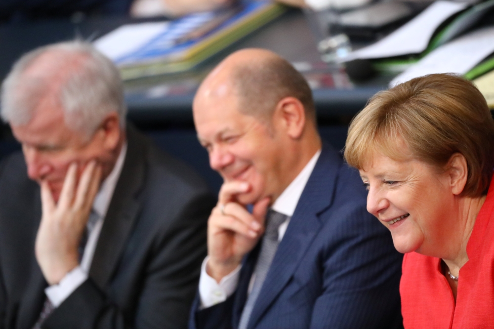German Chancellor Angela Merkel, Finance Minister Olaf Scholz and German Interior Minister Horst Seehofer attend a budget debate at the lower house of parliament Bundestag in Berlin, Germany, July 4, 2018. REUTERS/Hannibal Hanschke