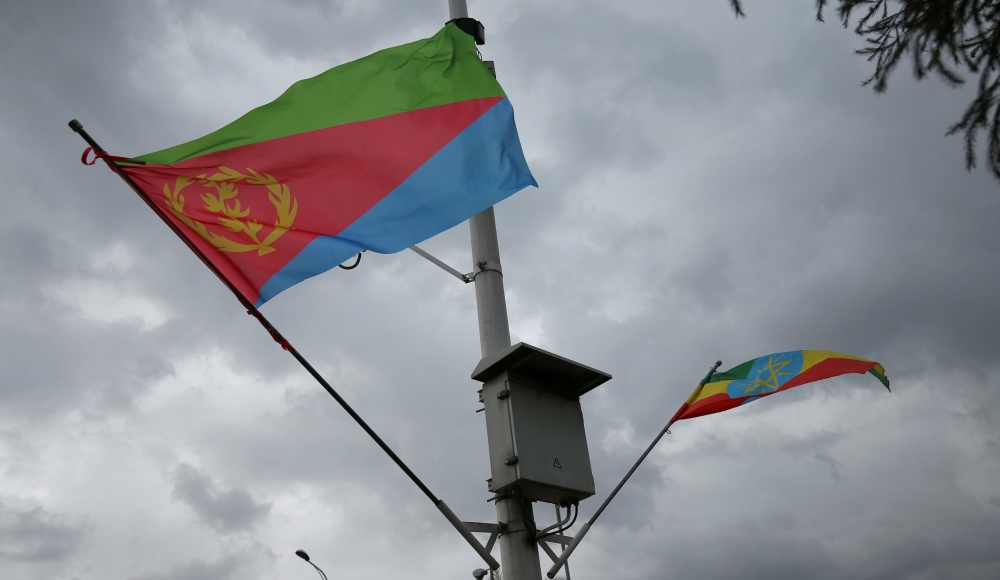 FILE PHOTO: Ethiopian and Eritrean flags flutter during the welcoming ceremony of Eritrean Foreign Minister Osman Saleh and his delegation at the Bole International Airport in Addis Ababa, Ethiopia June 26, 2018. REUTERS/Tiksa Negeri/File Photo