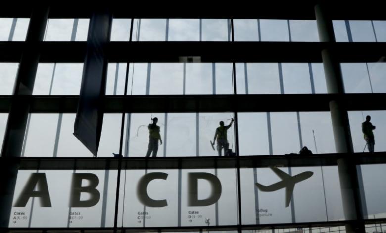 Workers clean the windows in the departure area at Vienna's airport in Schwechat April 2, 2014. Reuters/Leonhard Foeger