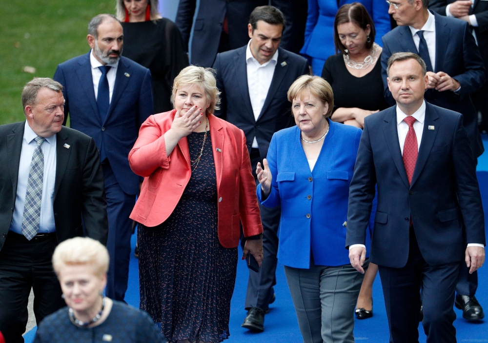 Denmark's PM Lars Lokke Rasmussen, Norway's PM Erna Solberg, German Chancellor Angela Merkel and Poland's President Andrzej Duda speak as they arrive for a working dinner at The Parc du Cinquantenaire - Jubelpark Park in Brussels on July 11, 2018, during 