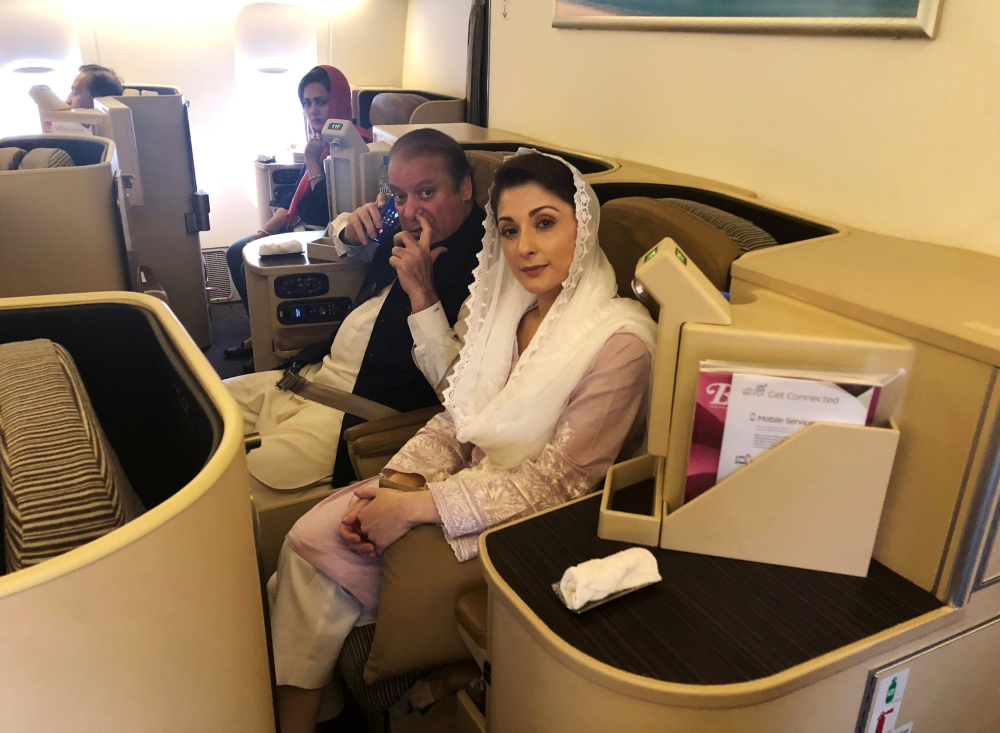 Ousted Pakistani Prime Minister Nawaz Sharif and his daughter Maryam sit on a Lahore-bound flight due for departure, at Abu Dhabi International Airport, UAE July 13, 2018. Reuters/Drazen Gorgic