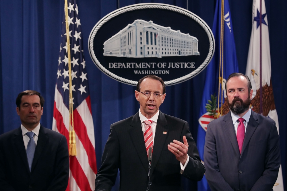 US Deputy Attorney General Rod Rosenstein (C), Acting Principal Associate Deputy Attorney General Edward O'Callaghan (R) and Assistant Attorney General John Demers and holds a news conference at the Department of Justice July 13, 2018 in Washington, DC. C