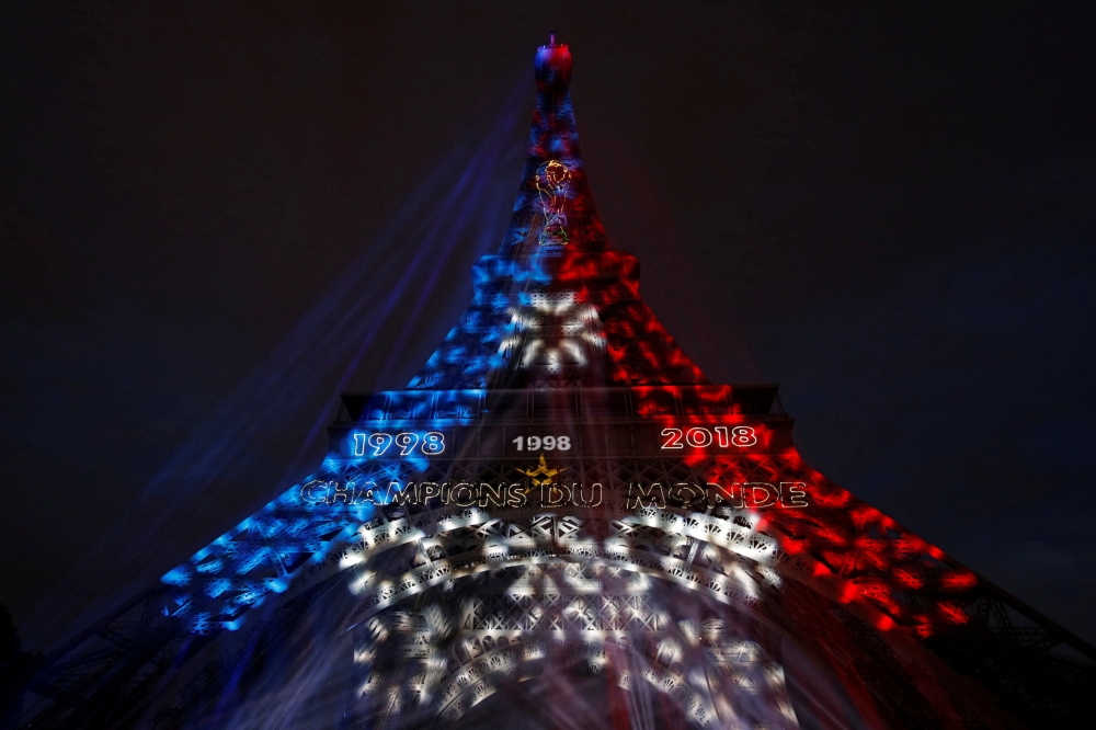 Blue, White, and Red lights and two World Cup stars are projected on the Eiffel Tower after France won the Soccer World Cup final, Paris, France, July 15, 2018. REUTERS/Philippe Wojazer