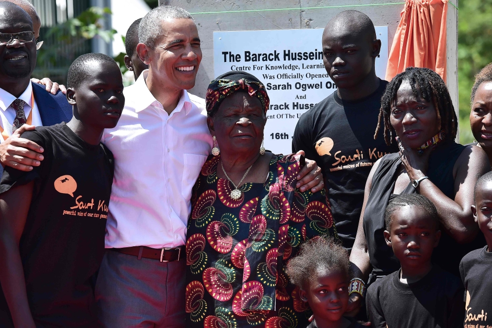 Former US President, Barak Obama (3L) poses for a picrure with his step-grandmother Sarah (C) and half-sister, Auma (2R) and some of the local youth on July 16, 2018 during the opening of the Sauti Kuu Resource Centre, founded by his half-sister, Auma Oba