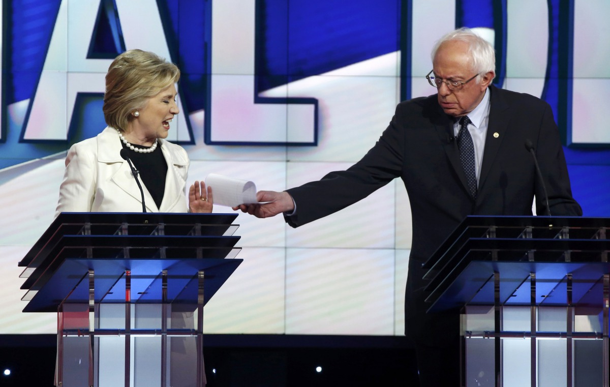 FILE PHOTO: Hillary Clinton reacts as rival Bernie Sanders tries to hand her a piece of paper during a Democratic debate hosted by CNN and New York One at the Brooklyn Navy Yard in New York, April 14, 2016. ( Reuters)