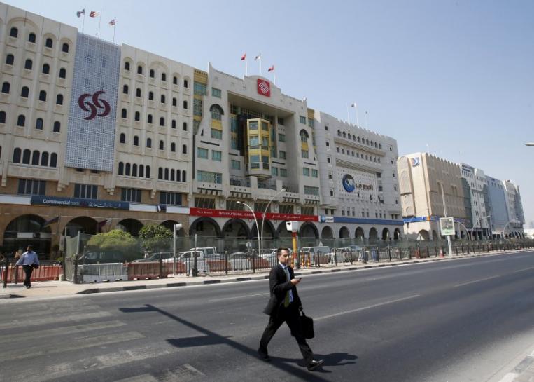 A man crosses Grand Hamad street where banks and financial institutions are located in Doha, Qatar (Reuters) 