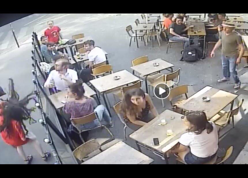 In surveillance video provided by the cafe, the man is then seen grabbing an ash tray from a table on the cafe's patio and throwing it at her.