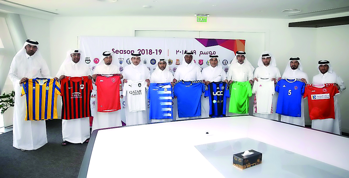 QNB Stars League team officials pose for a photograph with their playing jerseys during a technical meeting held at Al Bidda Tower yesterday. 