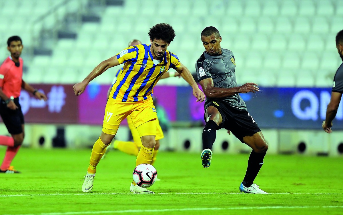 Al Gharafa’s Ahmed Alaaeldin Abdlmotaal (left) and Sandro Ferreira Nascimento of Qatar SC vie for the ball possession during their QNB Stars League (QSL) match at Al Sadd Stadium yesterday. 
Pic: Abdul Basit/The Peninsula