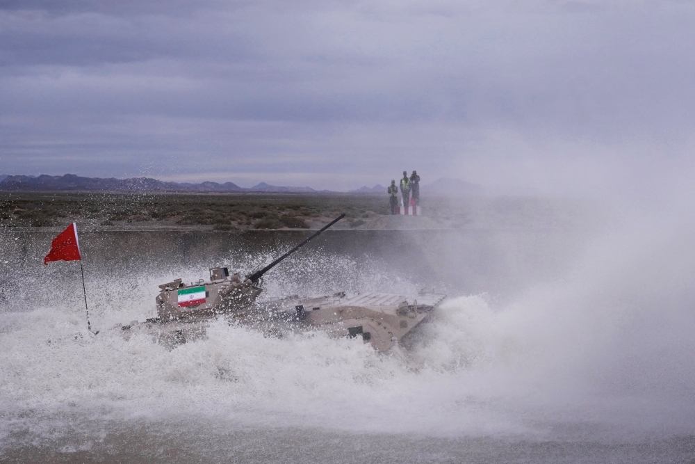 A tank drives through the water during the Suvorov Attack contest at the International Army Games 2018 in Korla, Xinjiang Uighur Autonomous Region, China July 30, 2018.  Zhang Zhitao/Southern Metropolis Daily via Reuters 