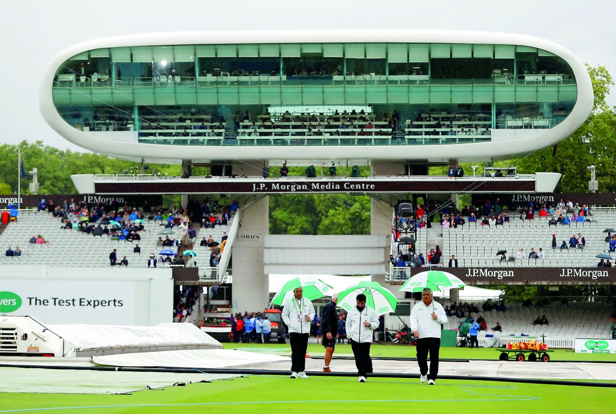 Umpires on the pitch during a rain delay. Reuters/Paul Childs 