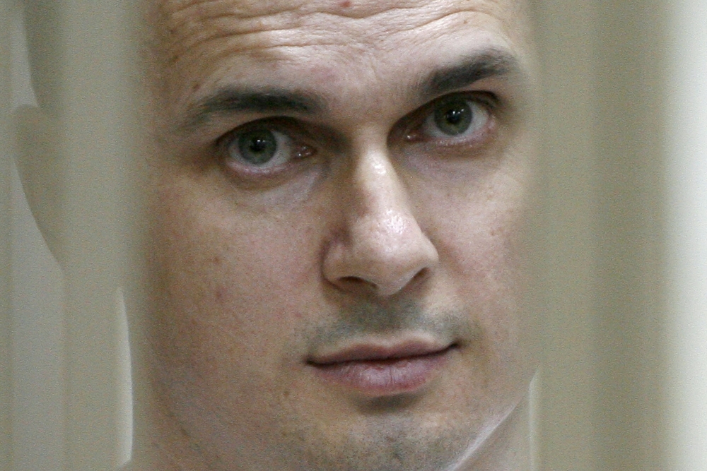In this file photo taken on July 22, 2015 shows Ukrainian film director Oleg Sentsov looking on inside a defendants' cage during a hearing at a military court in the city of Rostov-on-Don. / AFP / SERGEI VENYAVSKY 