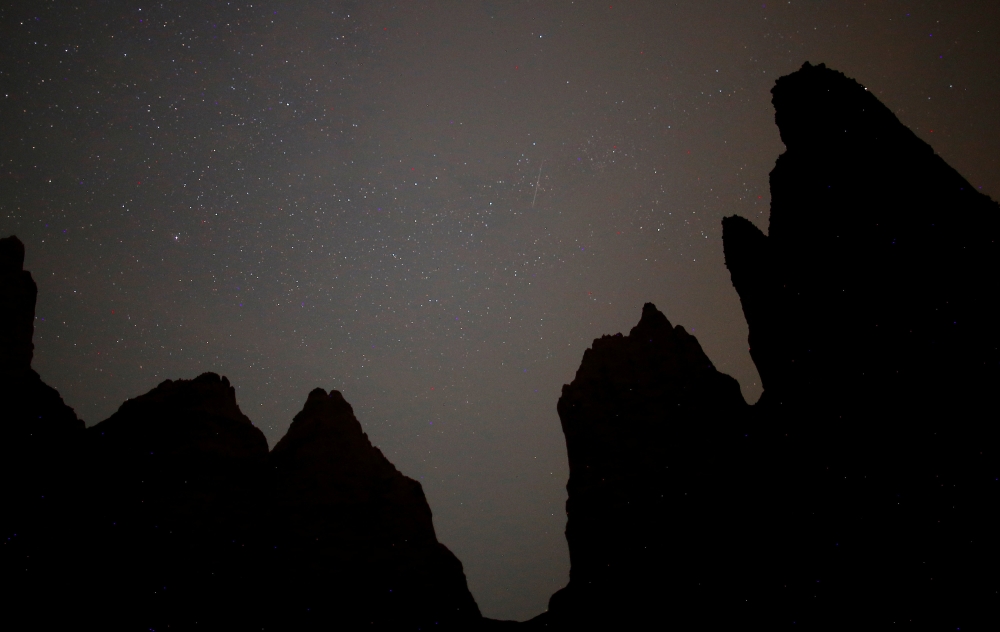 A meteor streaks across the skies over the Sand Pyramids during the peak of the Perseid meteor shower in the village of Miljevina near Foca, August 12, 2018. REUTERS/Dado Ruvic