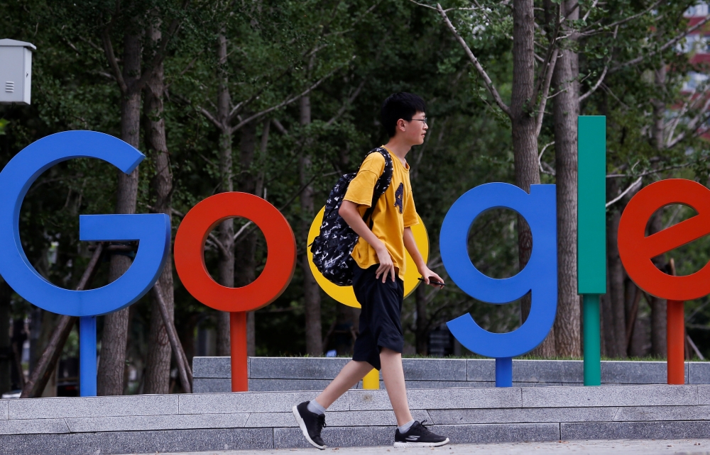 A man walks past the brand logo of Alphabet Inc's Google outside its office in Beijing, China, August 8, 2018. (REUTERS/Thomas Peter)