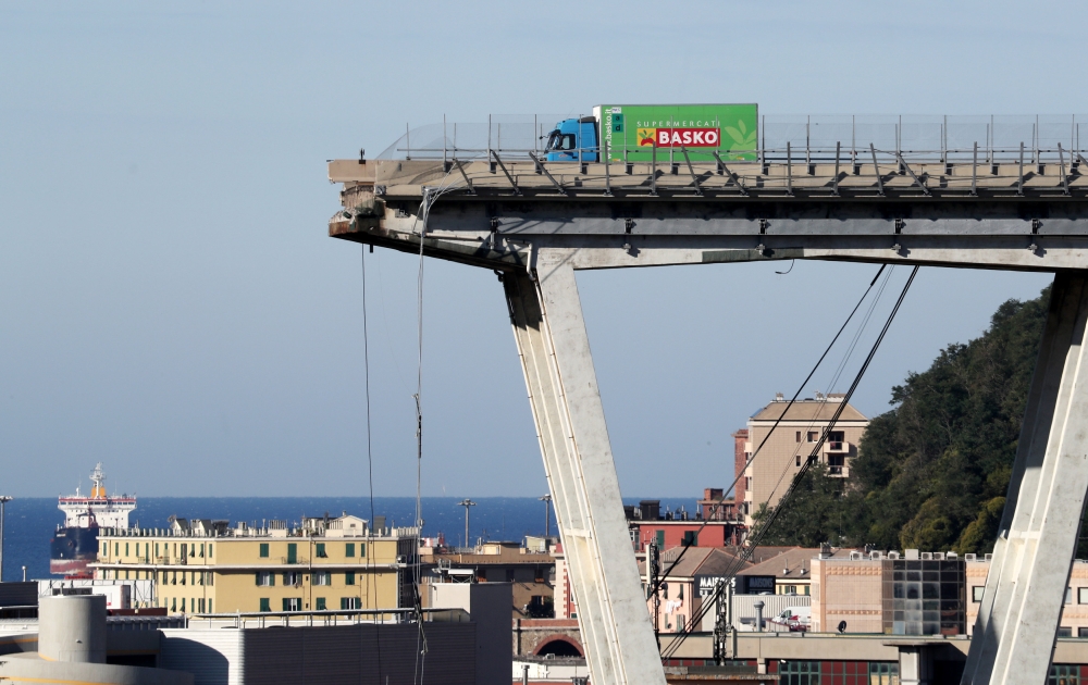 The collapsed Morandi Bridge is seen in the Italian port city of Genoa, Italy August 15, 2018. REUTERS/Stefano Rellandini