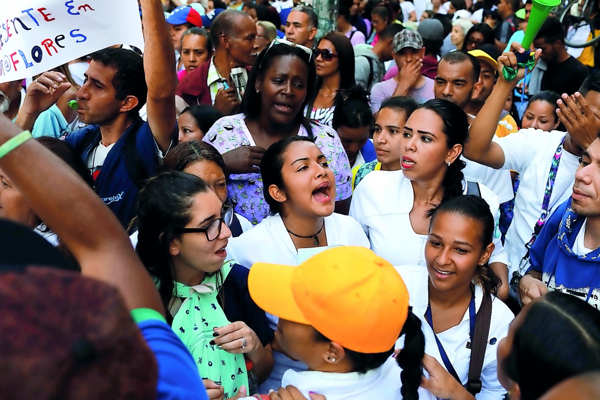 People shout as they take part in a protest of workers of the health sector due to the shortages of medicines and for higher wage, outside a public children hospital in Caracas, Venezuela August 16, 2018. Reuters/Marco Bello