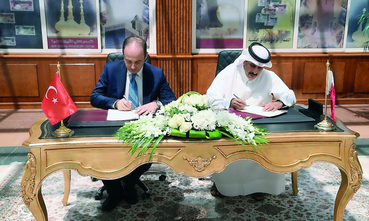 Qatar Central Bank Governor H E Sheikh Abdullah bin Saoud Al Thani and Governor of the Central Bank of the Republic of Turkey, Murat Cetinkaya, signing the agreement in Doha yesterday.