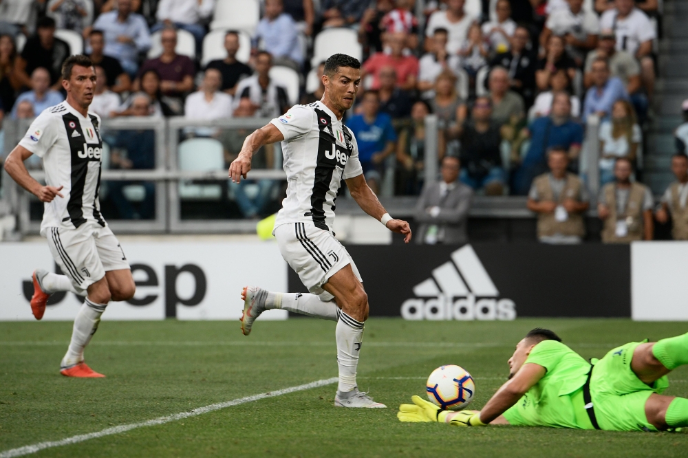 Lazio's Albanian goalkeeper Thomas Strakosha (R) defends against Juventus' Portuguese forward Cristiano Ronaldo during the Italian Serie A football match Juventus vs Lazio on August 25, 2018 at the Allianz Stadium in Turin. / AFP / Filippo MONTEFORTE