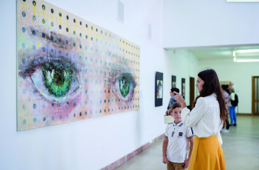Visitors watching the displays at the art exhibition, in Lviv, Ukraine.