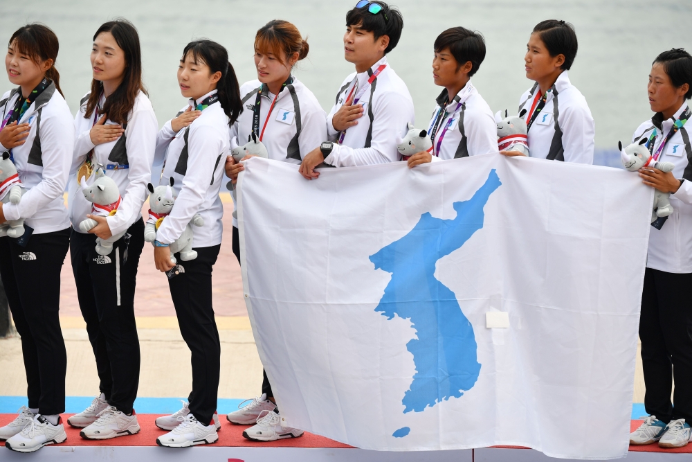 Unified Korea's gold medallists sing the national folk song 