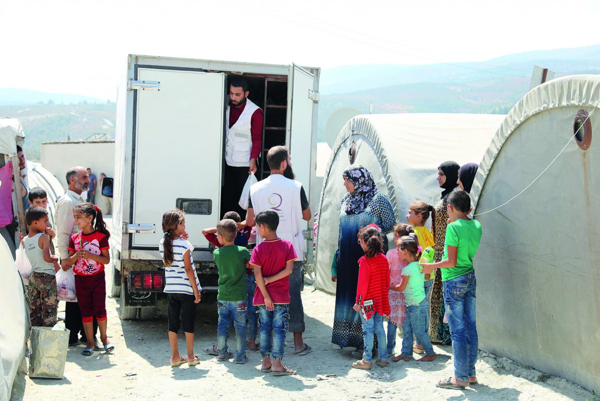 Refugees receiving sacrificial meat at a distribution centre.