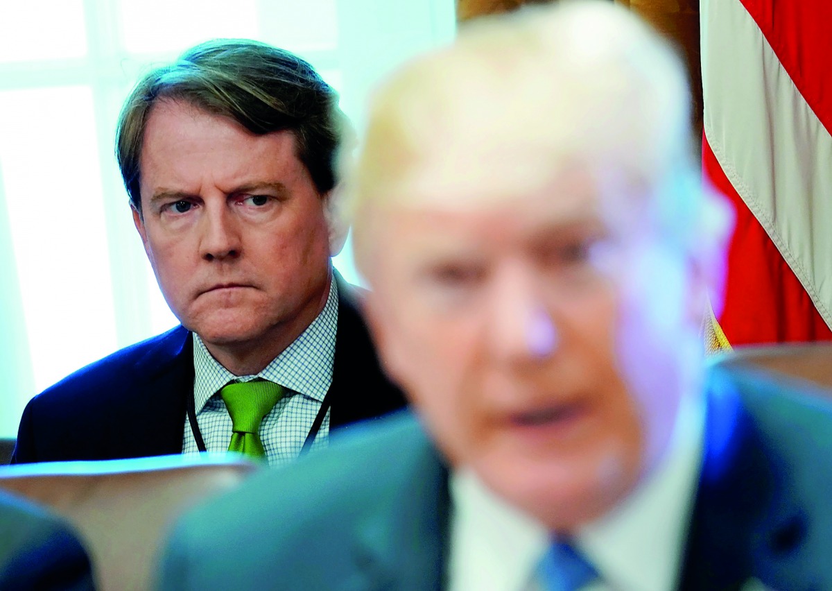 White House Counsel Don McGahn sits behind U.S. President Donald Trump as the president holds a cabinet meeting at the White House in Washington,  June 21, 2018. Reuters/Jonathan Ernst