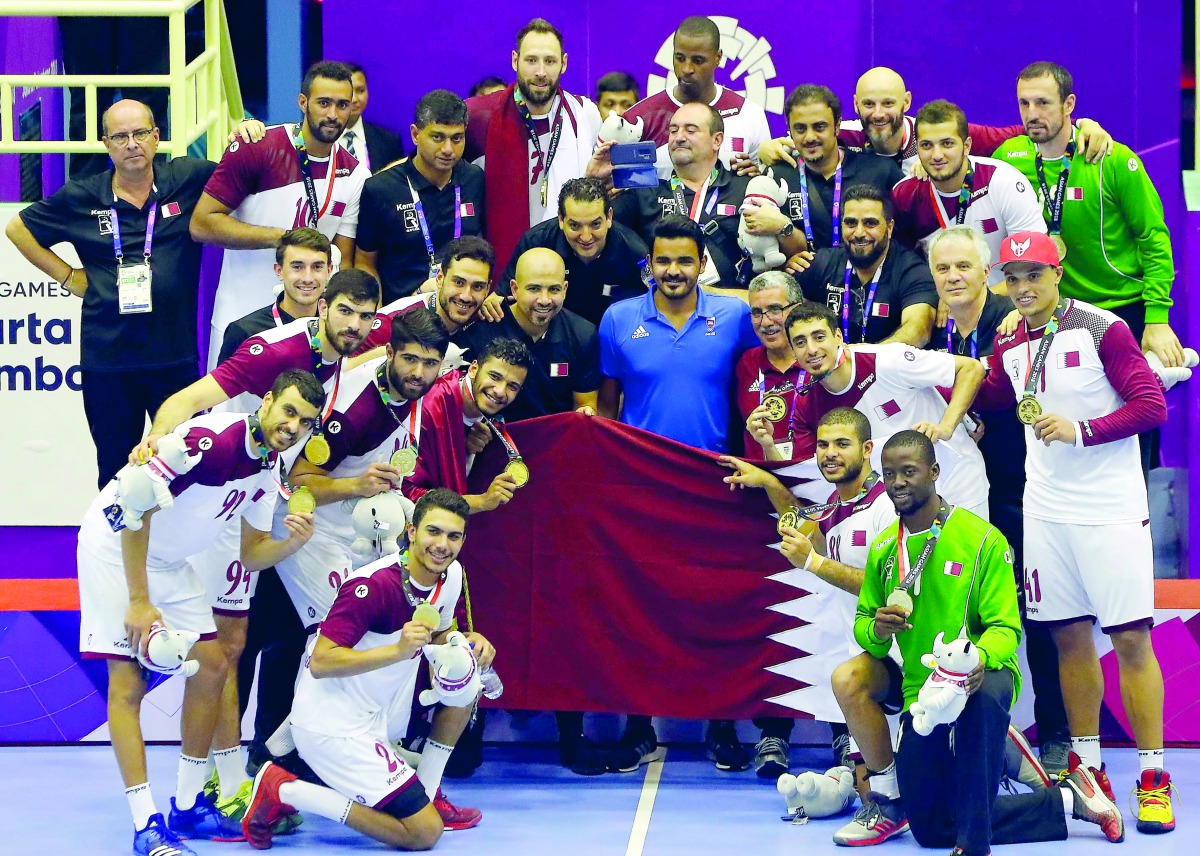 President of the Qatar Olympic Committee H E Sheikh Joaan bin Hamad Al Thani celebrates with the Qatari handball team after they won the gold medal, defeating Bahrain 32-27 in the final during the 2018 Asian Games in Jakarta yesterday.