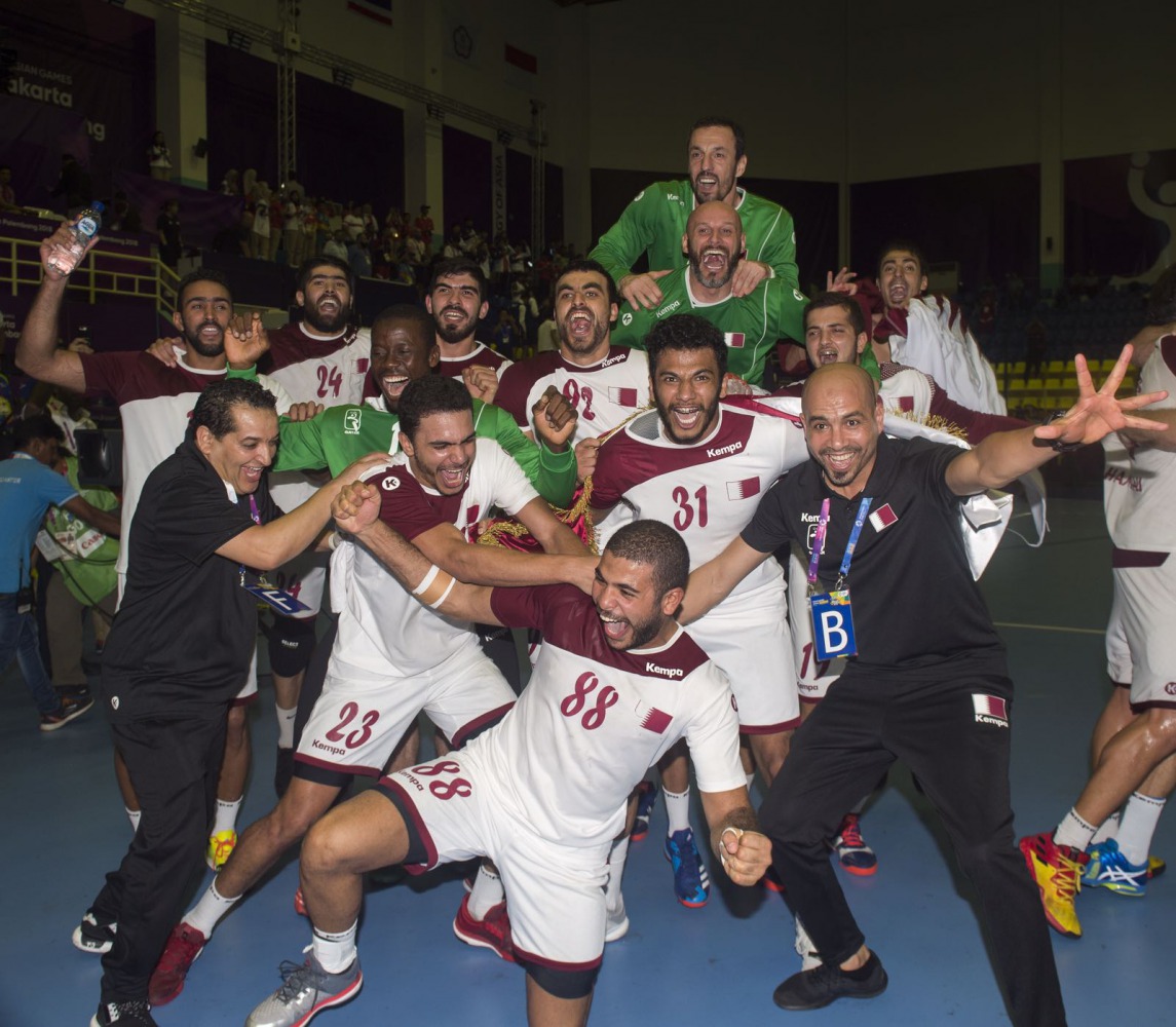 Jubilant Qatar handball players and officials celebrate after winning the gold medal, defeating Bahrain in the final.
