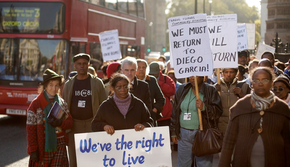 In this file photo taken on October 22, 2008 Chagos Islanders hold placards reading 