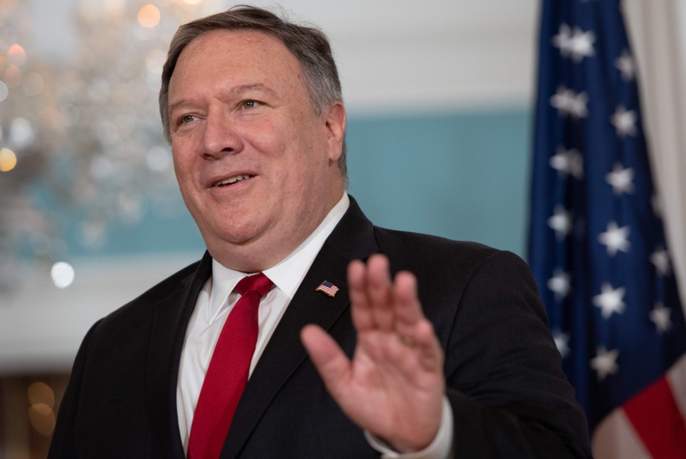 (FILES) In this file photo taken on August 21, 2018 US Secretary of State Mike Pompeo waves to the media during a photo opportunity prior to his meetings with Macedonian Minister of Foreign Affairs Nikola Dimitrov at the State Department in Washington, DC