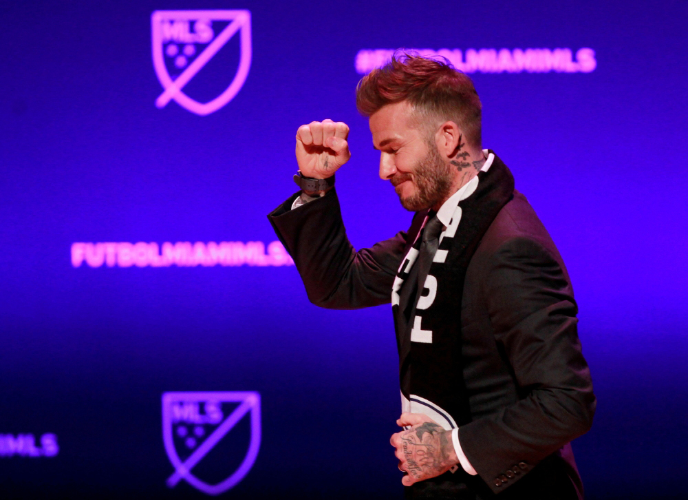 FILE PHOTO: David Beckham, wearing a league scarf, salutes a section of the crowd at this official announcement for Miami's MLS expansion team in Miami, Florida, U.S. January 29, 2018. REUTERS/Andrew Innerarity