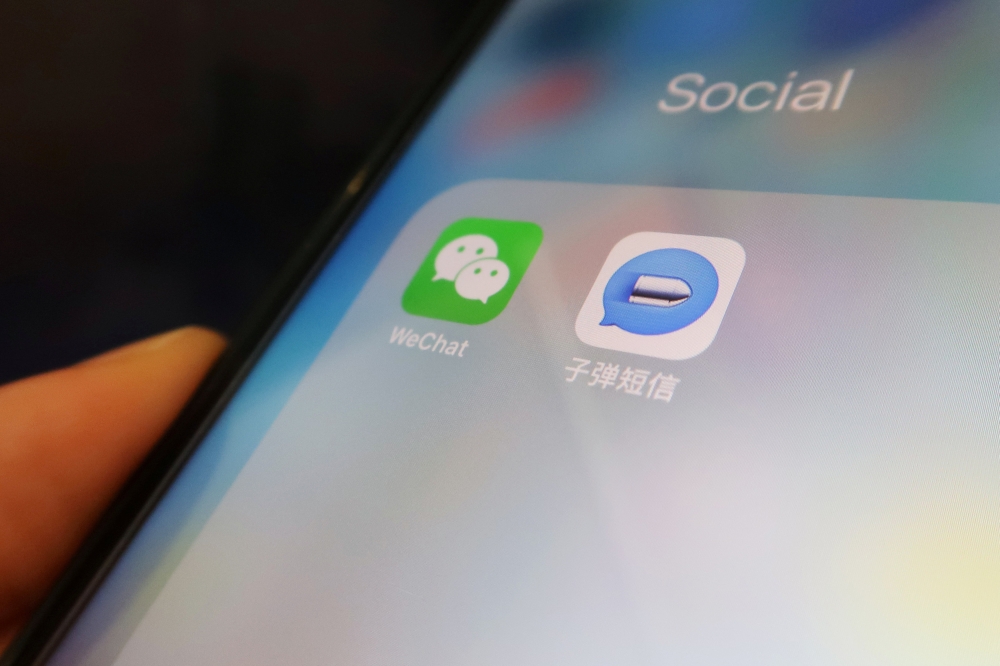 Chinese instant messaging app Bullet Messenger is seen next to Tencent's Wechat app on a mobile phone in this illustration picture taken September 4, 2018. REUTERS/Florence Lo/Illustration