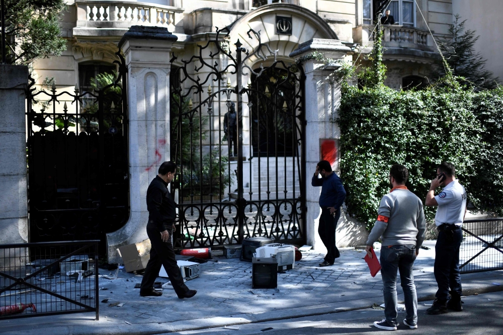 Computers litter the pavement outside the Iranian Embassy in the French capital Paris on September 14, 2018, after people taking part in a demonstration in a near by street split off and walked to the Iranian embassy where they sprayed red paint on the Em