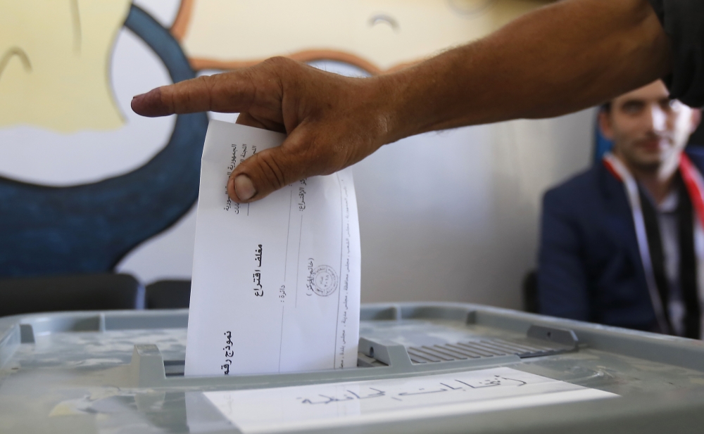 A man casts his ballot for Syria's first local elections since 2011, on September 16, 2018 in the southern Eastern Ghouta, on the eastern outskirts of the capital Damascus.   AFP / LOUAI BESHARA
