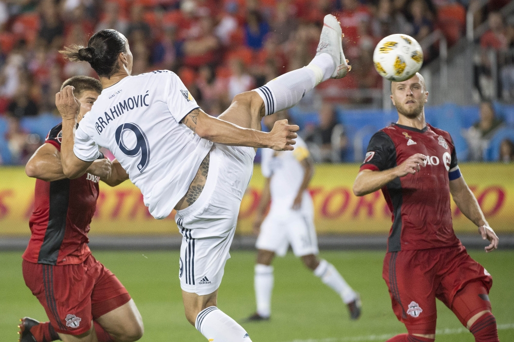 Los Angeles Galaxy forward Zlatan Ibrahimovic (9) scores a goal during the first half against Toronto FC at BMO Field. Mandatory Credit: Nick Turchiaro