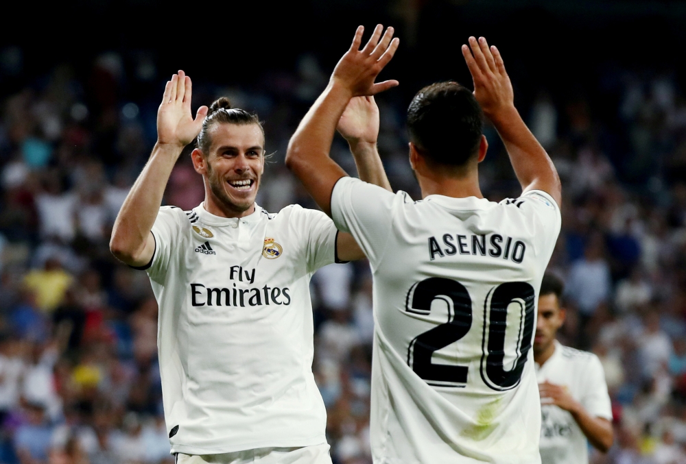 Real Madrid's Gareth Bale celebrates with Marco Asensio at Santiago Bernabeu, Madrid, Spain - August 19, 2018. REUTERS/Sergio Perez/File Photo