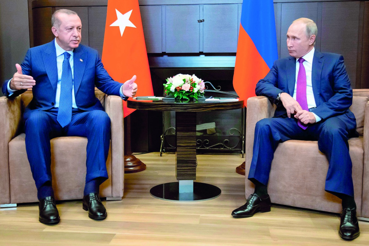 Russian President Vladimir Putin (R) talks to Turkish President Recep Tayyip Erdogan during their meeting in the Bocharov Ruchei residence in the Black Sea resort of Sochi in Sochi on September 17, 2018. AFP / Alexander Zemlianichenko