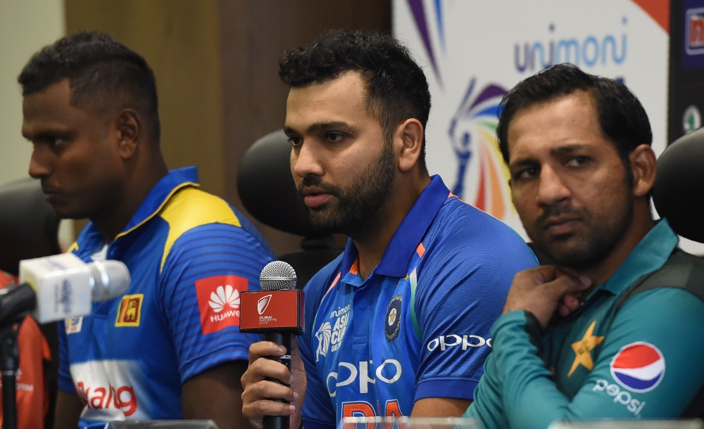 Indian cricket team captain Rohit Sharma (C) speaks during an Asia Cup press conference as Sri Lankan cricket team captain Angelo Mathews (L) and Pakistan cricket captain Sarfraz Ahmed (R) look on at the Dubai International Cricket Stadium in Dubai on Sep