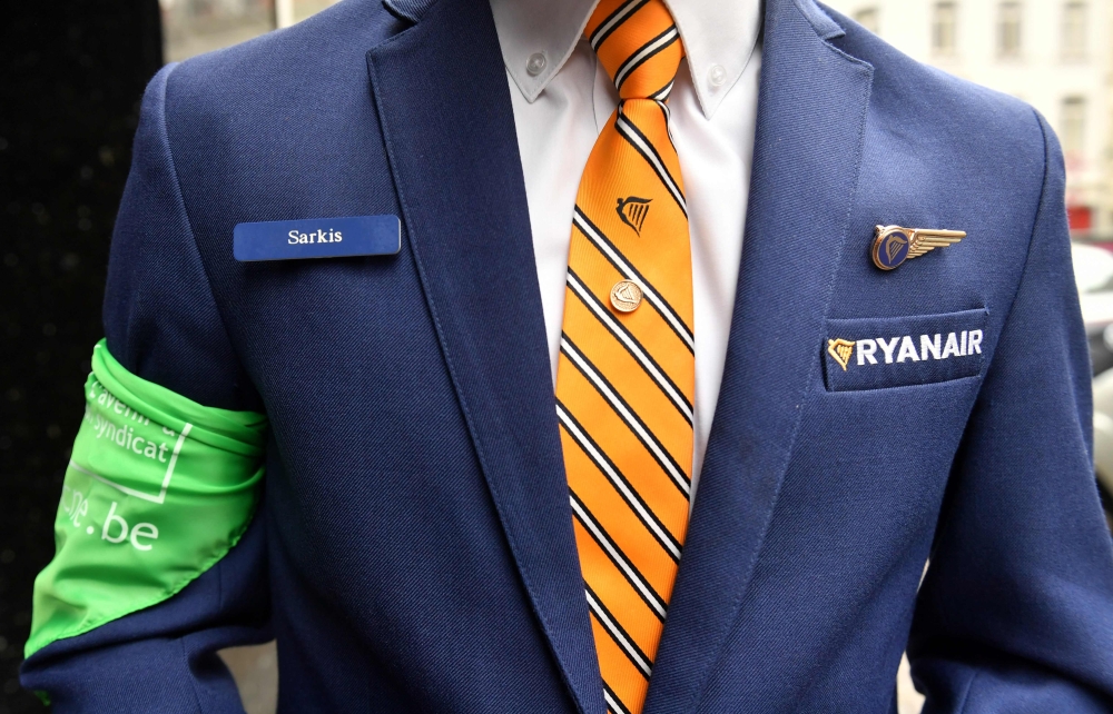 A Ryanair cabin crew member and union representative arrives ahead of a press conference held by Ryanair unions representatives, in Brussels, on September 13, 2018. AFP / Emmanuel Dunand 