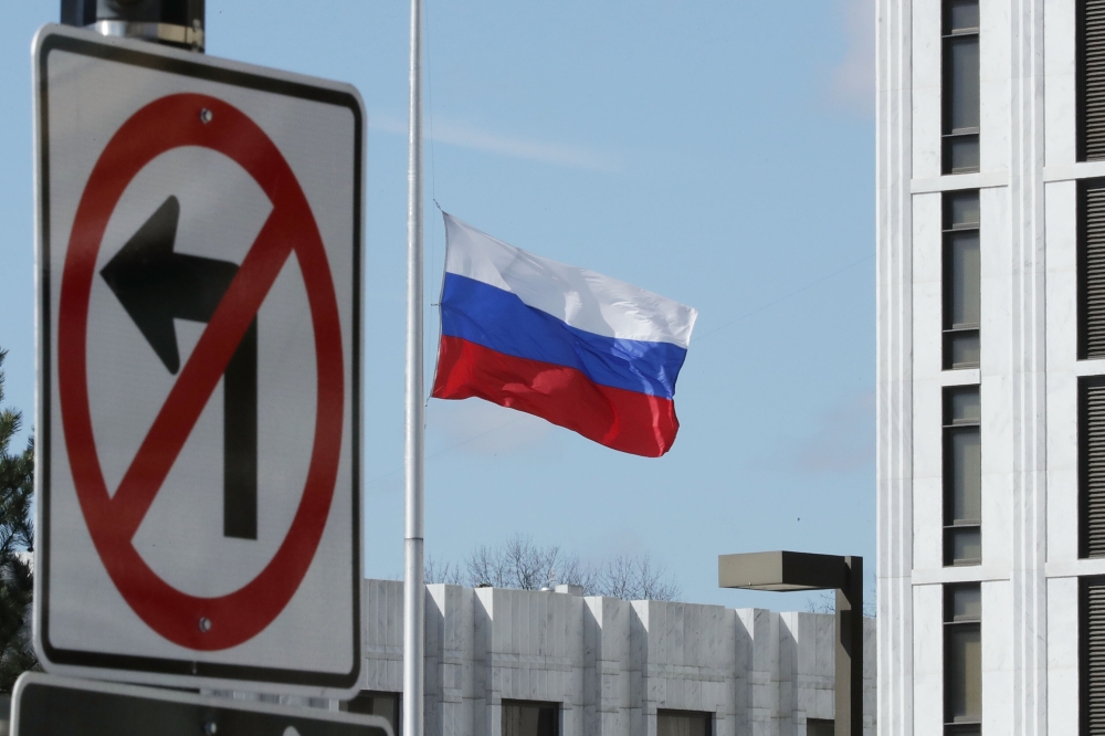 In this file photo taken on March 26, 2018, the Russian Federation flag flies in front of its embassy in Washington, DC.  / AFP / GETTY IMAGES NORTH AMERICA / CHIP SOMODEVILLA 
