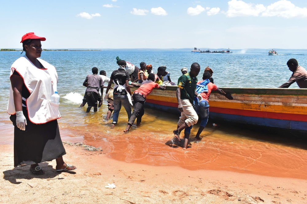 Rescuers push a boat to the water on Lake Victoria on September 22, 2018, during searches for victims a day after the ferry MV Nyerere capsized.   AFP / Casmir ODUOR
