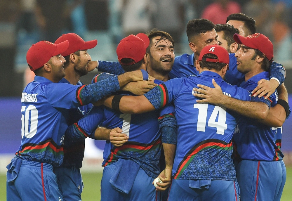 Afghan cricketer Rashid Khan (C), captain Asghar Afghan (R) celebrates with teammate after Match tied during the one day international (ODI) Asia Cup cricket match between Afghanistan and India at the Dubai International Cricket Stadium in Dubai on Septem