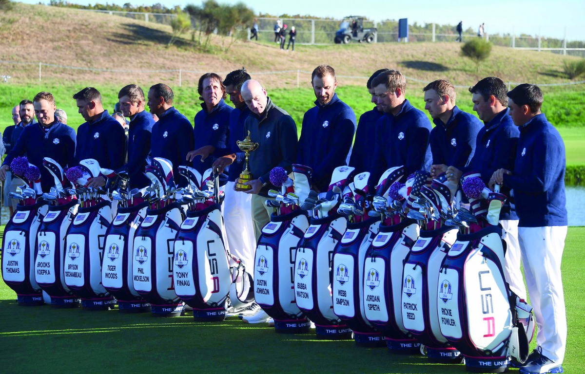 US team captain Jim Furyk (C) looks at his players as they take part in a team photograph ahead of the 42nd Ryder Cup at Le Golf National Course at Saint-Quentin-en-Yvelines, south-west of Paris on September 26, 2018. AFP / Franck Fife

