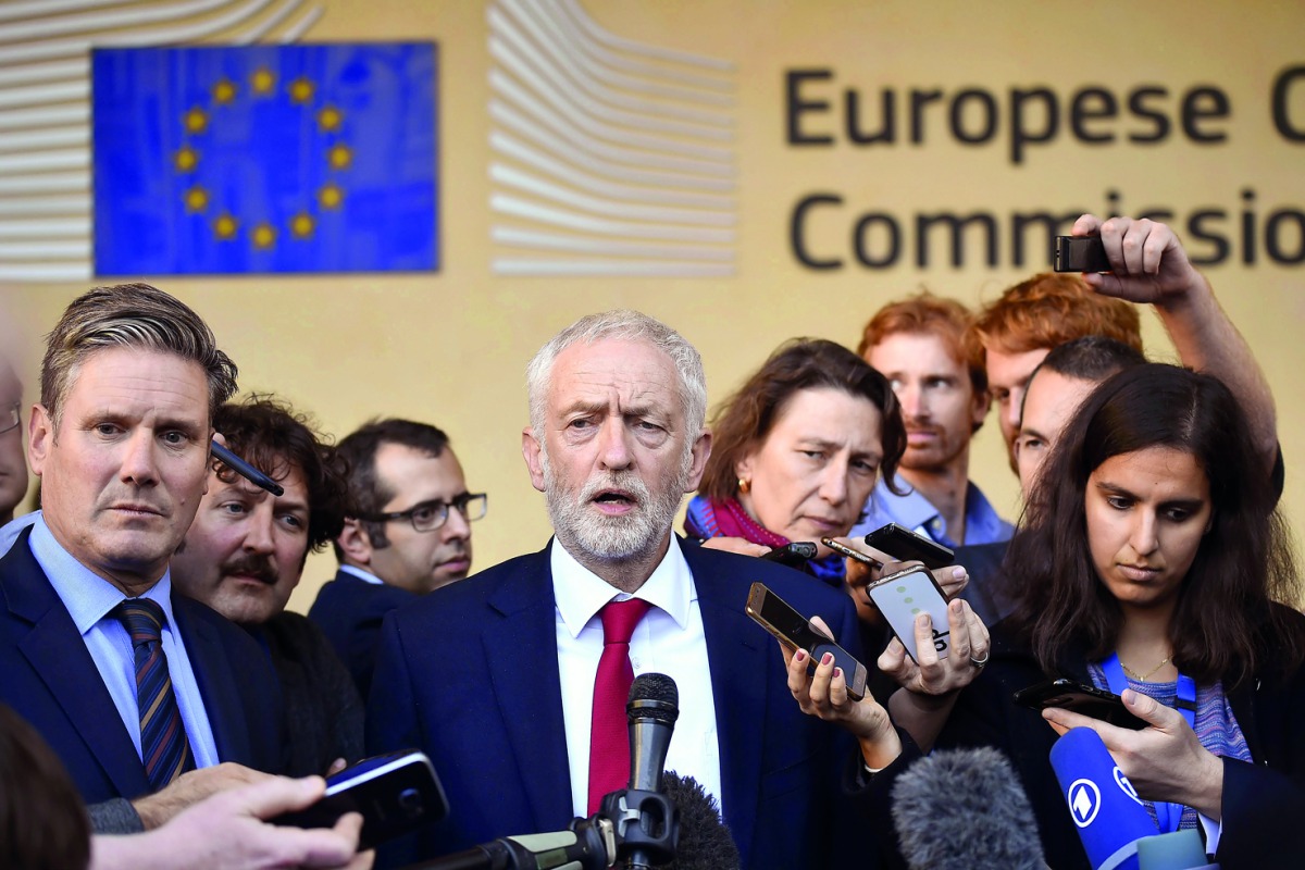 Labour Party leader Jeremy Corbyn (C), next to Labour's Brexit pointman Keir Starmer (L), gives a press conference after the meeting with senior EU officials in Brussels after warning he may oppose any Brexit deal negotiated by the London government, at B