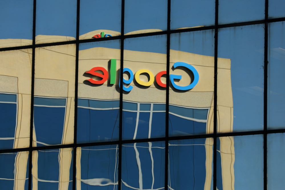 The Google logo is shown reflected on an adjacent office building in Irvine, California, August 7, 2017. Reuters / Mike Blake